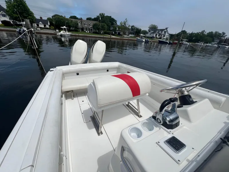 Slide: The Image of 1994 Wellcraft 302 Scarab Sport boat with dual Suzuki 250 engines docked by waterfront homes. - 5