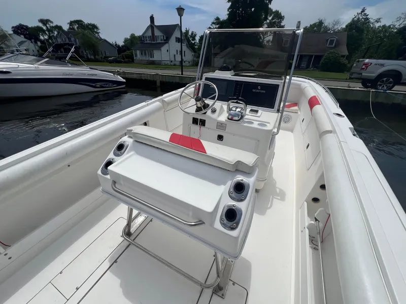Slide: The Image of 1994 Wellcraft 302 Scarab Sport boat with 250 Suzuki engine, docked near waterfront homes. - 7