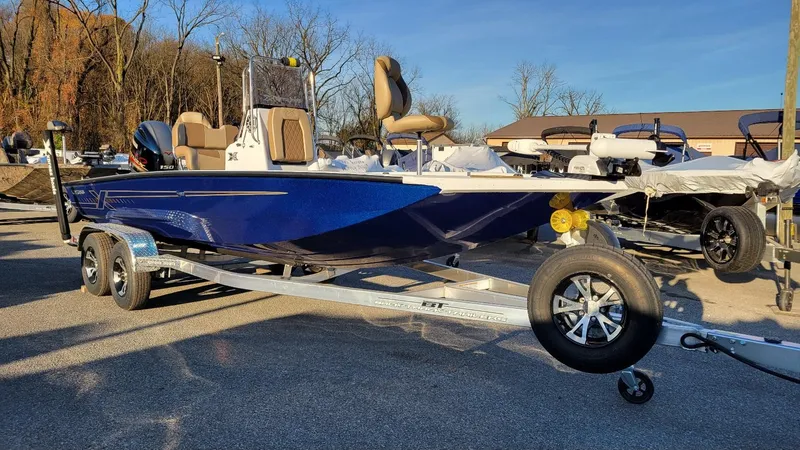 Slide: The Image of 2025 Xpress H20 Bay boat with Yamaha Vmax 150, blue, on trailer, in stock. - 15