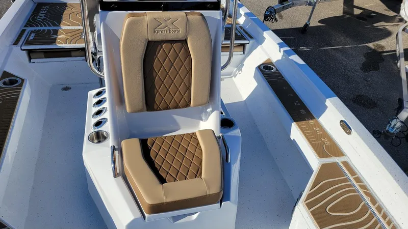 Slide: The Image of 2025 Xpress H20 Bay boat interior with brown diamond-stitched seating and Yamaha Vmax 150 engine. - 17