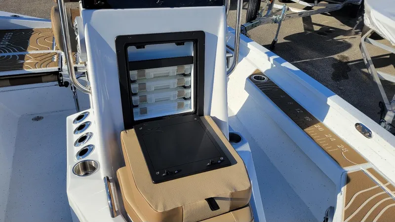 Slide: The Image of 2025 Xpress H20 Bay boat interior with storage compartments and rod holders. - 18