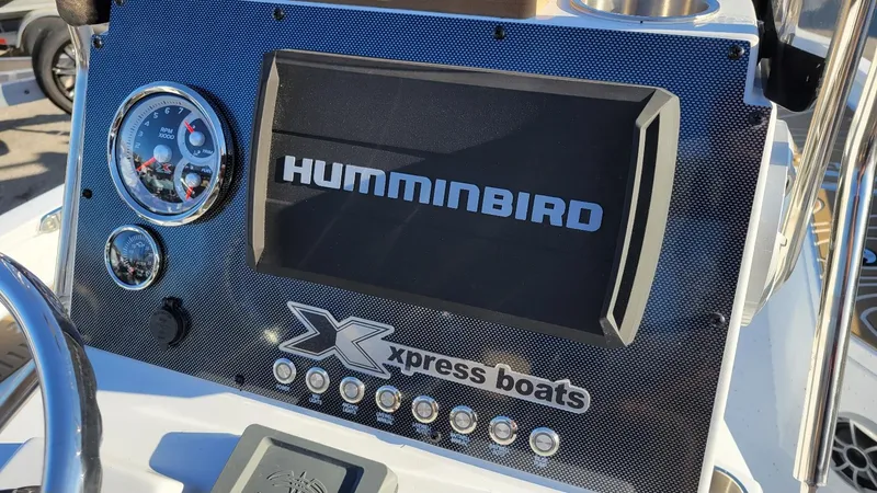 Slide: The Image of Dashboard of 2025 Xpress H20 Bay boat featuring Humminbird display and gauges. - 21