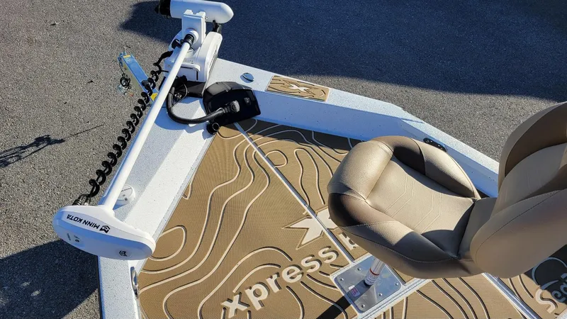 Slide: The Image of 2025 Xpress H20 Bay boat deck with Minn Kota trolling motor and beige seat. - 6