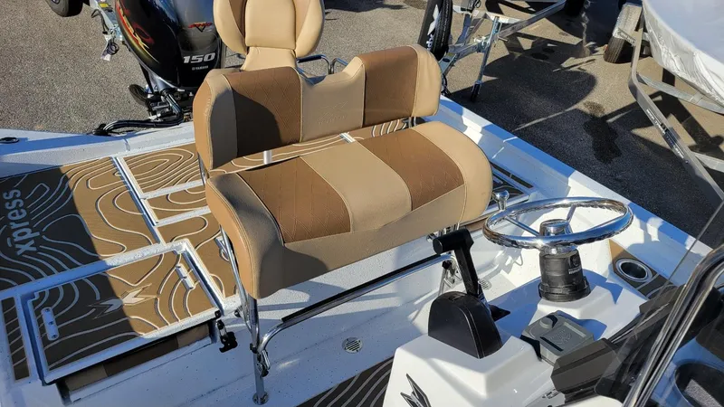 Slide: The Image of 2025 Xpress H20 Bay boat interior with Yamaha Vmax 150 engine, featuring tan seating and steering console. - 8