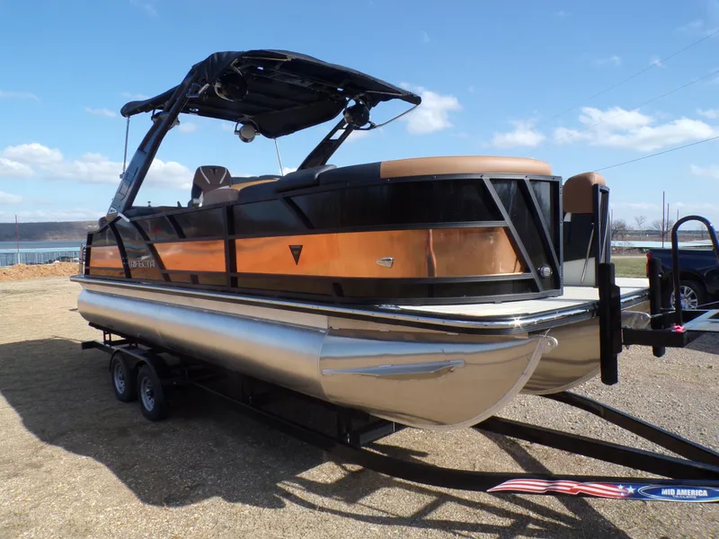 Slide: The Image of 2024 Trifecta 23 RF SS With Arch pontoon boat on trailer. - 1