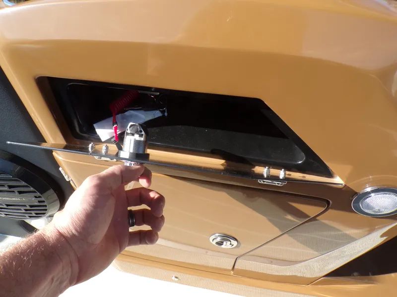 Slide: The Image of Hand opening compartment on 2024 Trifecta 23 RF SS With Arch boat. - 15