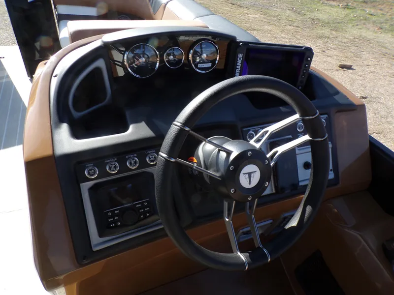 Slide: The Image of 2024 Trifecta 23 RF SS With Arch boat dashboard and steering wheel. - 21