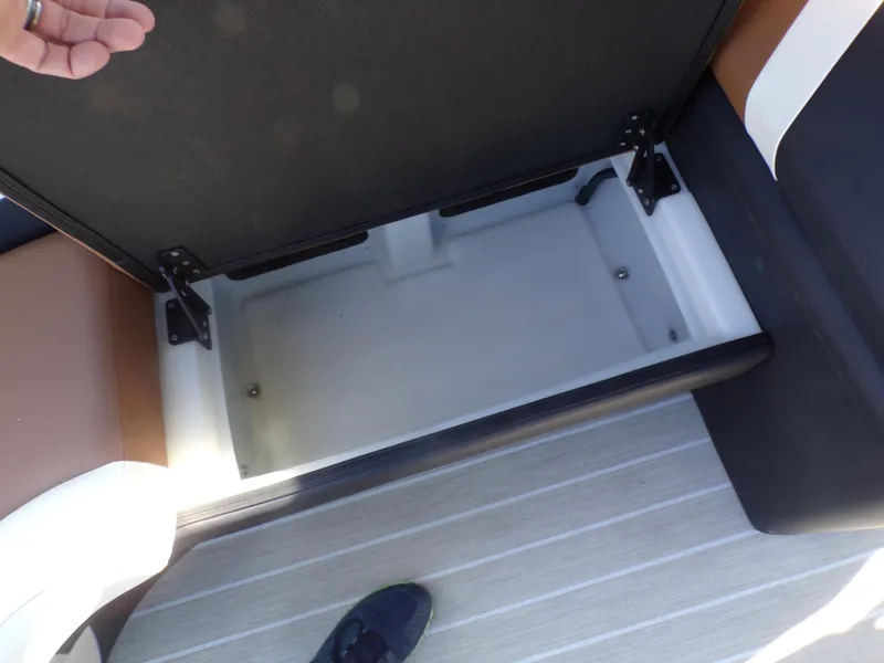 Slide: The Image of Open storage compartment in 2024 Trifecta 23 RF SS With Arch boat. - 24