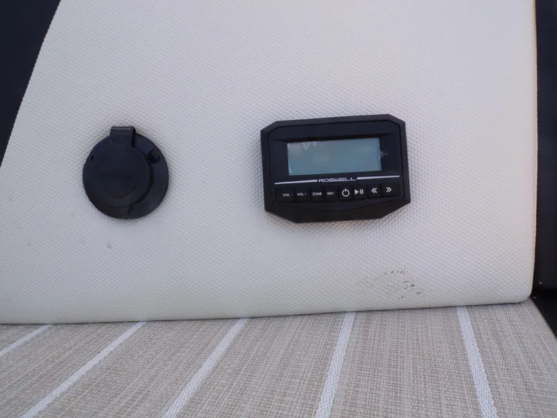 Slide: The Image of Control panel and outlet on 2024 Trifecta 23 RF SS With Arch boat. - 35