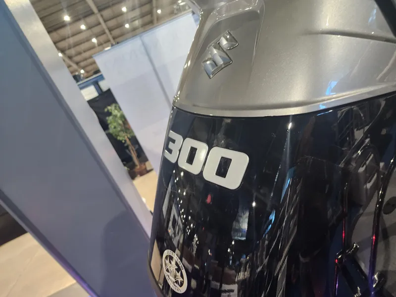 Slide: The Image of 2024 Trifecta 23 RF SS With Arch, Suzuki 300 outboard motor at a boat show. - 4