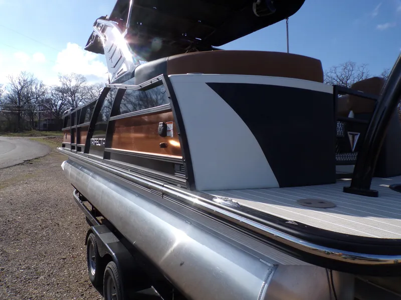 Slide: The Image of 2024 Trifecta 23 RF SS With Arch pontoon boat, side view, on a trailer. - 40