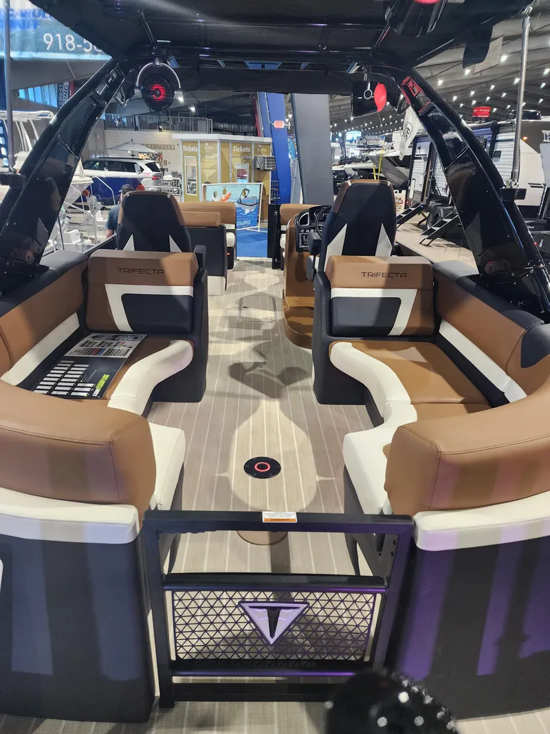 Slide: The Image of 2024 Trifecta 23 RF SS With Arch luxury pontoon boat interior at a boat show. - 5