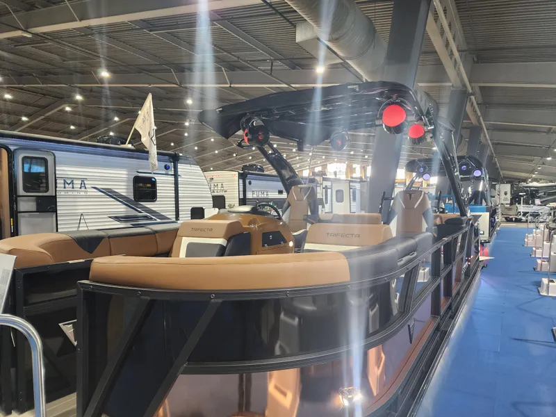 Slide: The Image of 2024 Trifecta 23 RF SS With Arch pontoon boat displayed indoors. - 7