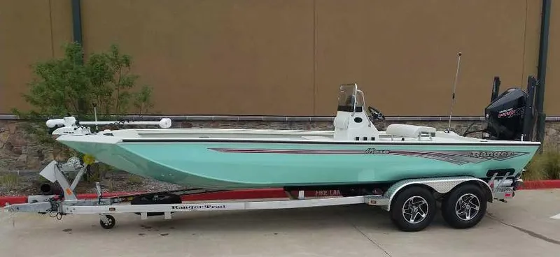 Slide: The Image of 2024 Ranger RB210 boat on a trailer, mint green hull, dual-axle trailer. - 0