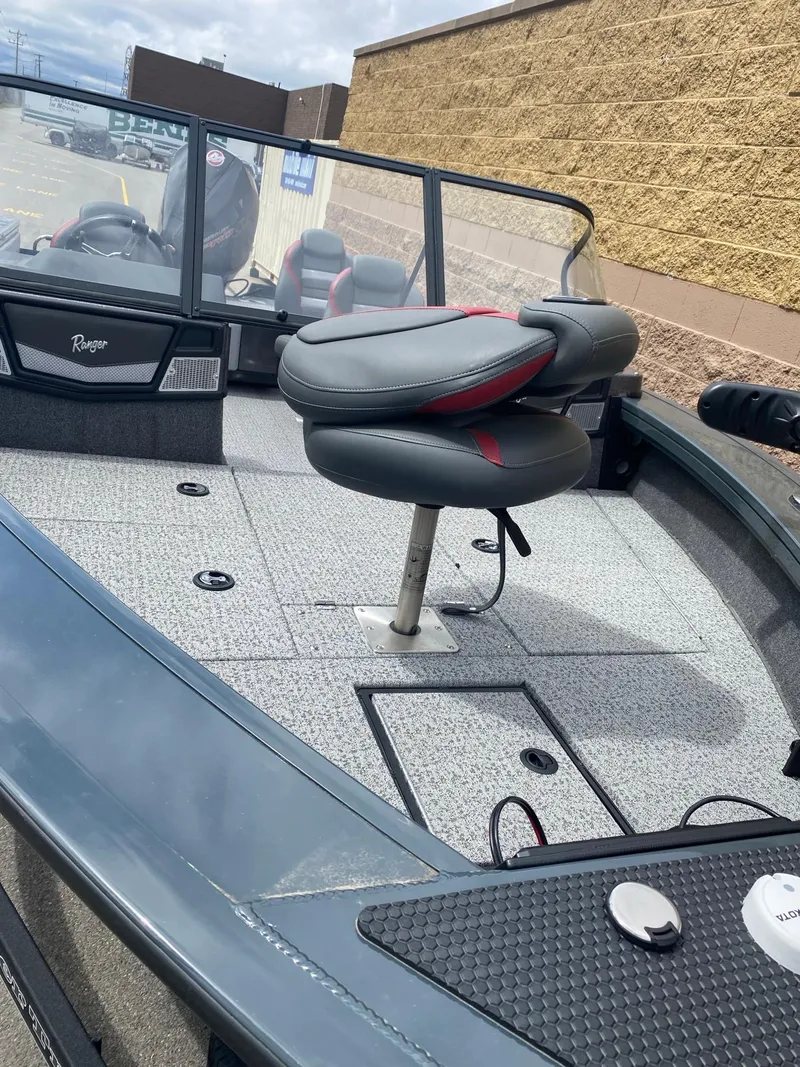 Slide: The Image of 2024 Ranger VX1988 WT boat with seating and deck details, parked outdoors. - 3