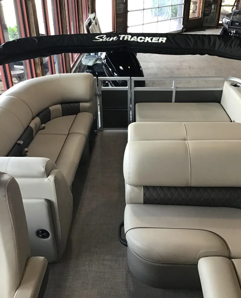 Slide: The Image of 2024 Sun Tracker Party Barge 22 RF DLX interior with plush seating and spacious layout. - 2