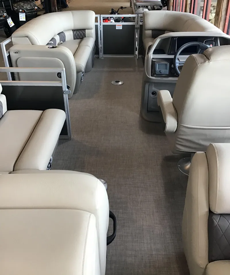 Slide: The Image of 2024 Sun Tracker Party Barge 22 RF DLX interior with plush seating and modern helm. - 3