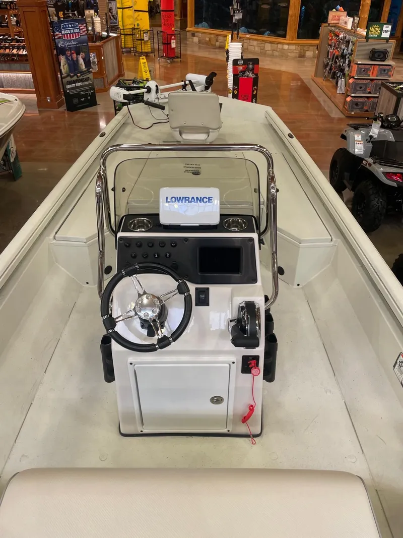 Slide: The Image of 2024 Ranger RB210 boat on trailer, parked on a concrete road. - 3