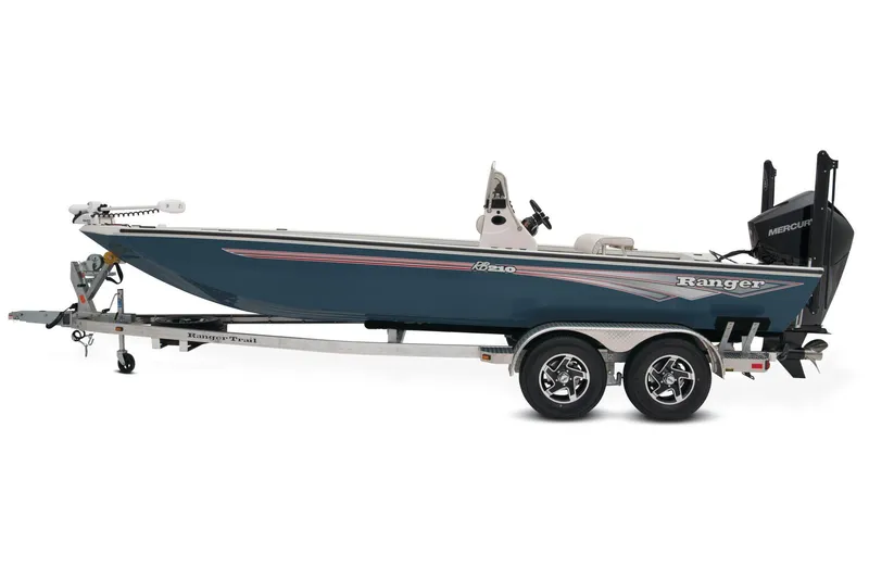 Slide: The Image of 2024 Ranger RB210 boat deck with control panel and seating, parked on concrete. - 6