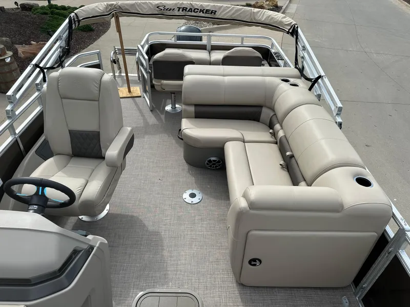 Slide: The Image of 2024 Sun Tracker SportFish 22 XP3 pontoon boat interior with beige seating. - 5