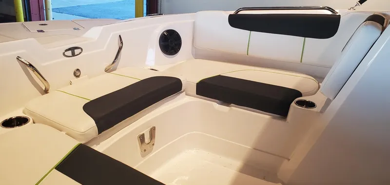 Slide: The Image of 2024 Tahoe 1950 boat interior with cushioned seating and cup holders. - 8