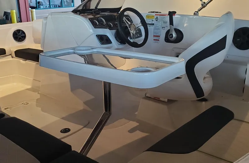 Slide: The Image of 2024 Tahoe 1950 boat interior with steering wheel and seating area. - 9