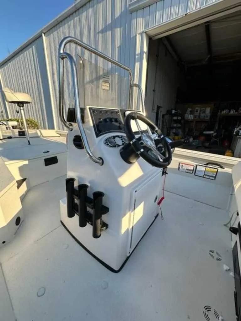 Slide: The Image of 2024 Ranger RB190 boat console with steering wheel and rod holders. - 3