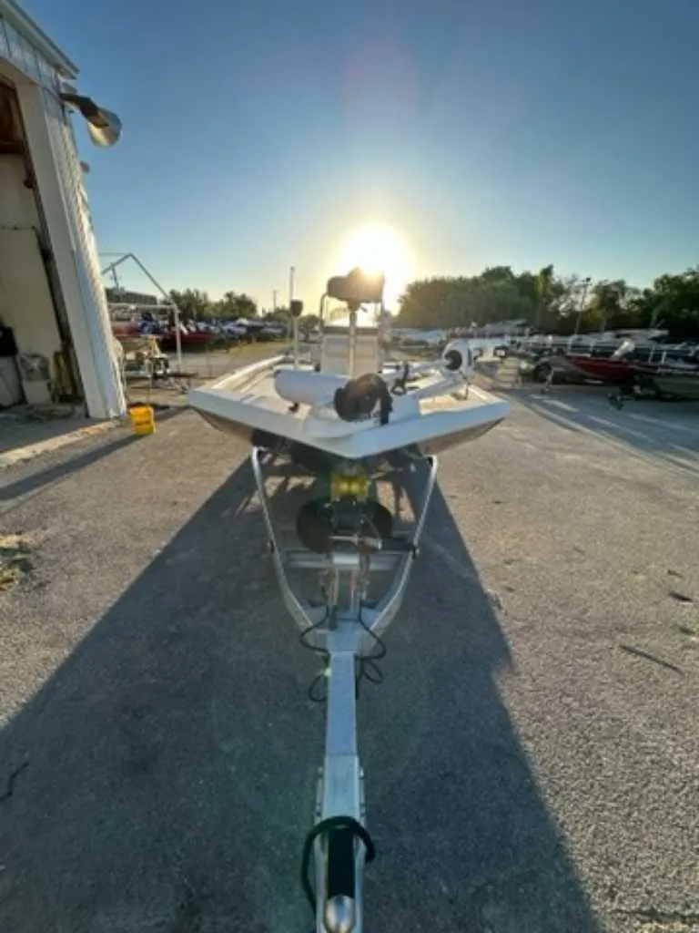 Slide: The Image of 2024 Ranger RB190 boat on trailer at sunset near a storage facility. - 4