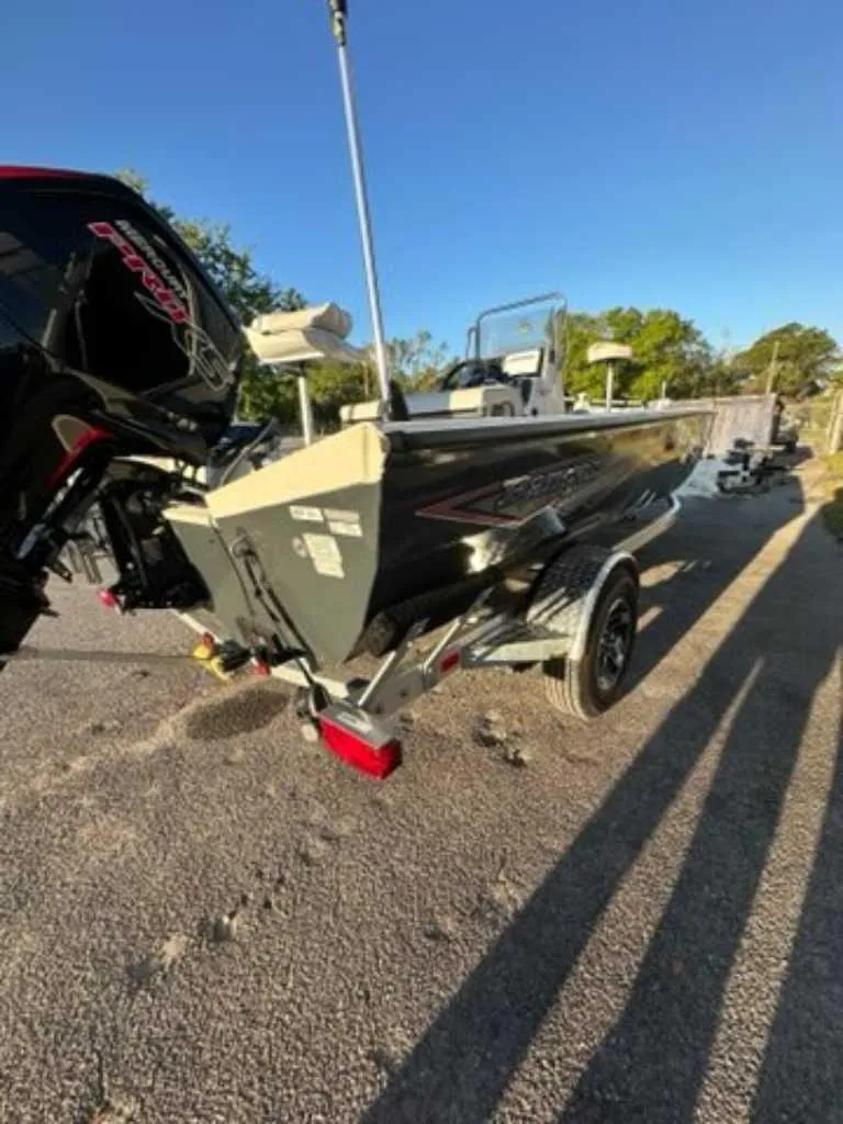 Slide: The Image of 2024 Ranger RB190 boat on a trailer in a sunny outdoor setting. - 6