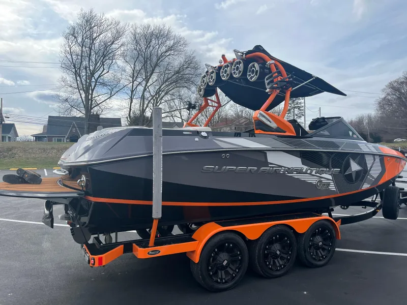 Slide: The Image of 2013 Nautique G23 boat on a trailer with orange accents. - 3