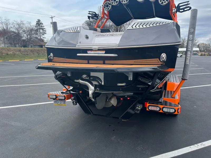 Slide: The Image of 2013 Nautique G23 boat rear view in parking lot. - 4