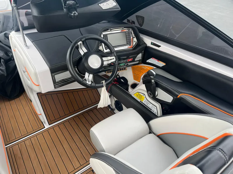 Slide: The Image of 2013 Nautique G23 boat interior with modern dashboard and steering wheel. - 9