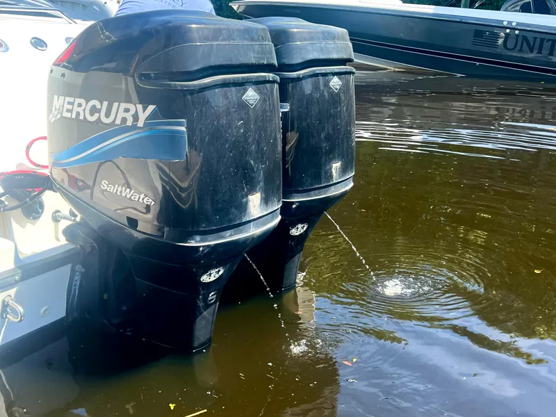 Slide: The Image of Twin Mercury outboard engines on a 2003 Boston Whaler 290 Outrage boat. - 10