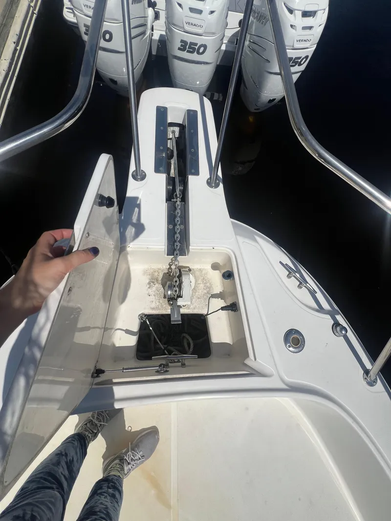 Slide: The Image of 2003 Boston Whaler 290 Outrage boat anchor compartment with triple 350 HP engines. - 12