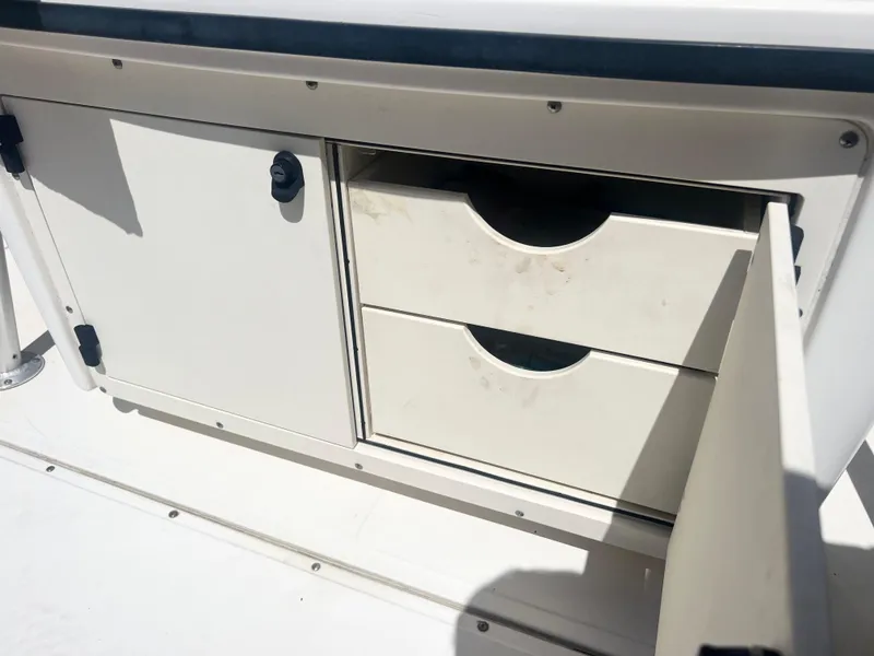 Slide: The Image of Storage compartment with drawers on a 2003 Boston Whaler 290 Outrage boat. - 13