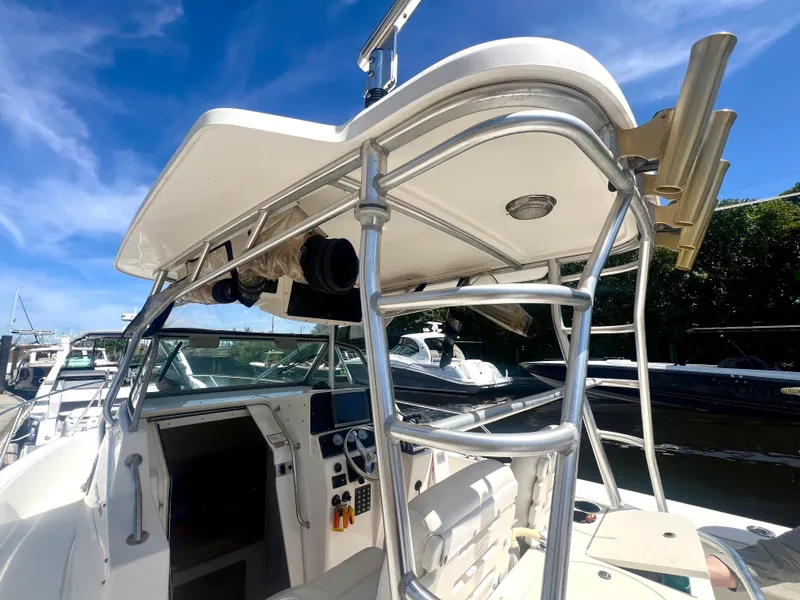 Slide: The Image of 2003 Boston Whaler 290 Outrage boat with T-top and helm station. - 2
