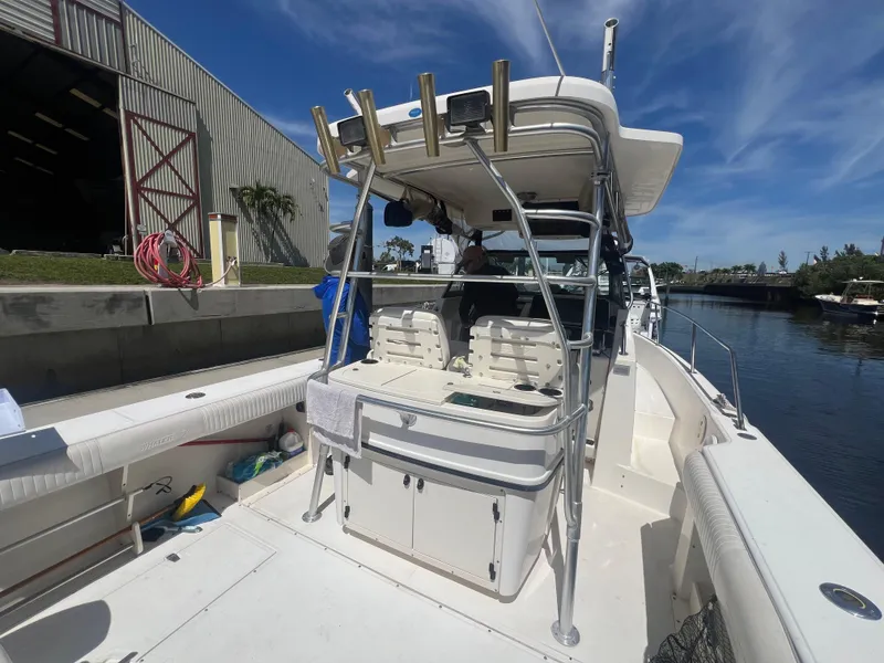 Slide: The Image of 2003 Boston Whaler 290 Outrage boat docked near a warehouse. - 3