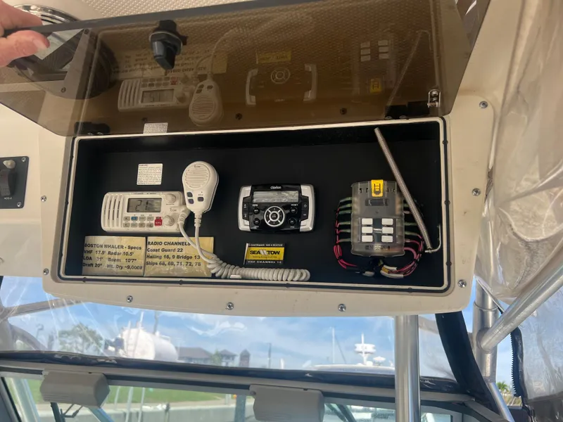 Slide: The Image of 2003 Boston Whaler 290 Outrage dashboard with radio and control panel. - 6