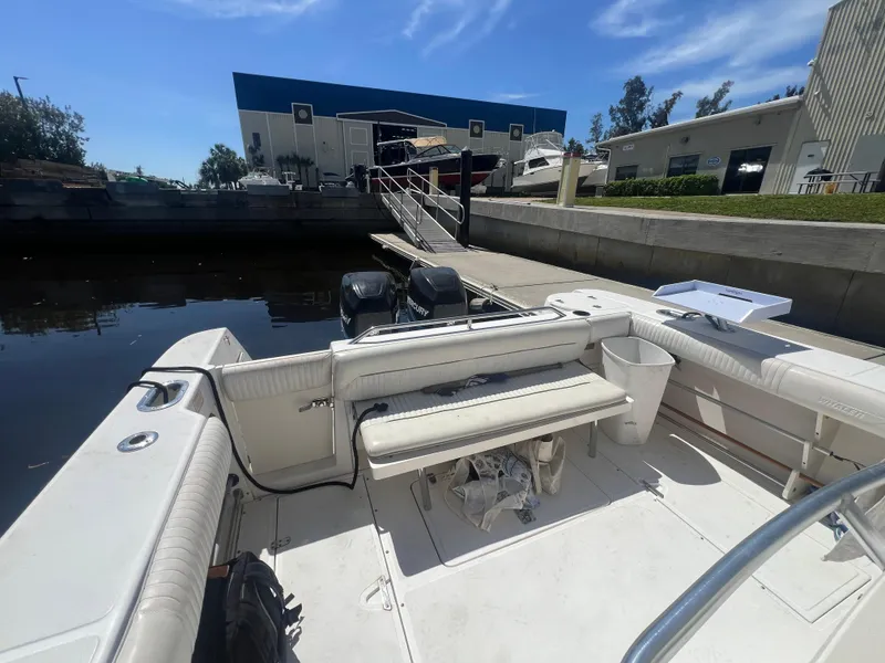 Slide: The Image of 2003 Boston Whaler 290 Outrage boat docked at a marina. - 7