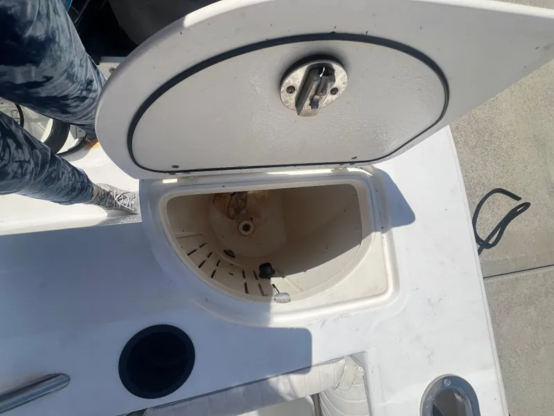 Slide: The Image of Open storage compartment on a 2003 Boston Whaler 290 Outrage boat. - 8