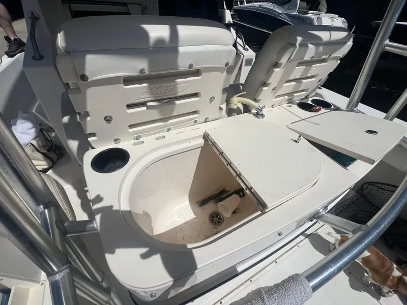 Slide: The Image of 2003 Boston Whaler 290 Outrage boat seating and storage compartments. - 9