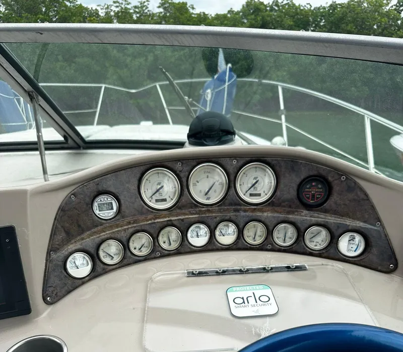 Slide: The Image of Dashboard of a 2006 Four Winns 328 Vista boat with gauges and controls. - 18