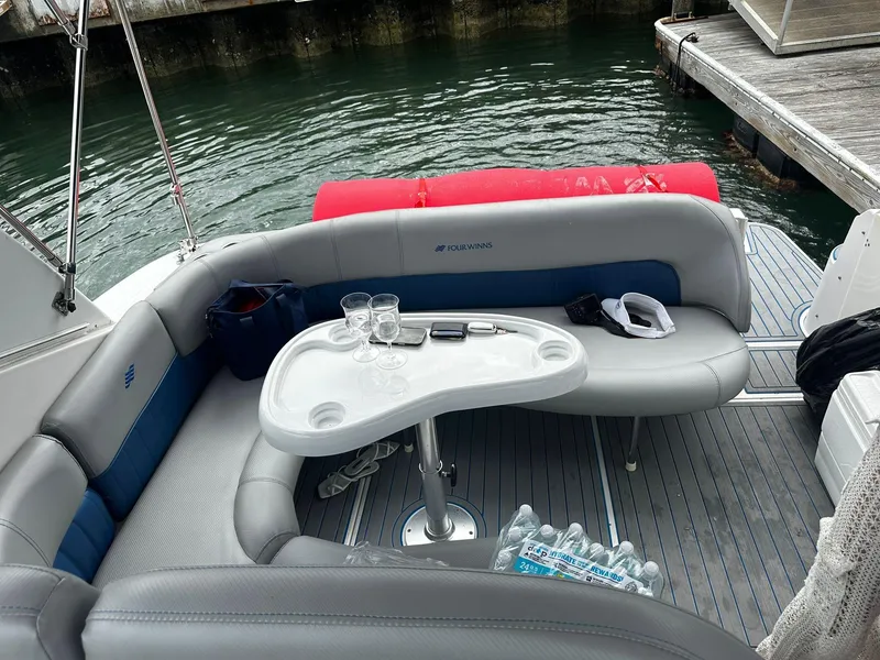 Slide: The Image of 2006 Four Winns 328 Vista boat interior with seating and table by the dock. - 24