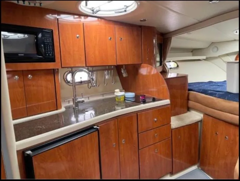Slide: The Image of 2006 Four Winns 328 Vista yacht interior with kitchenette and sleeping area. - 26
