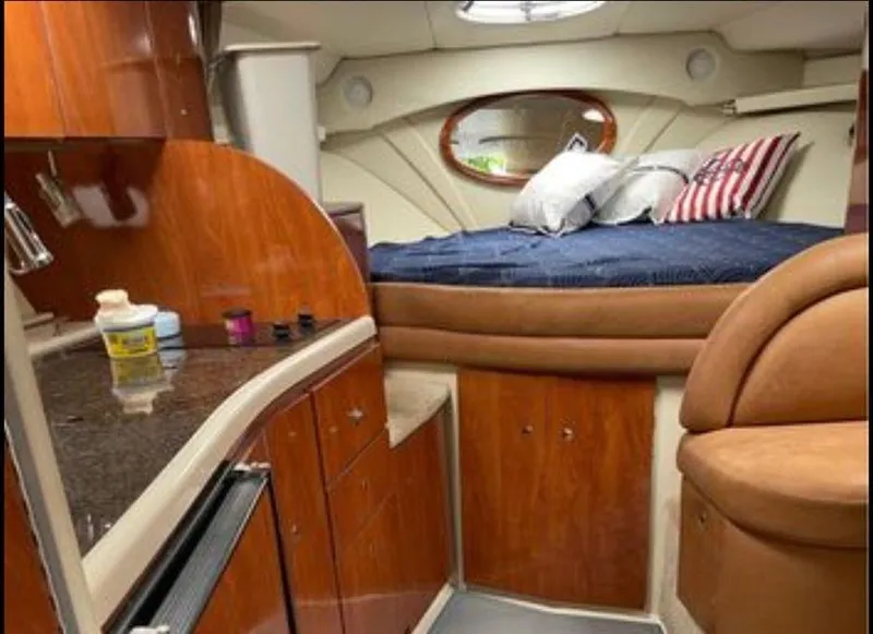 Slide: The Image of 2006 Four Winns 328 Vista cabin interior with kitchenette and bed. - 27