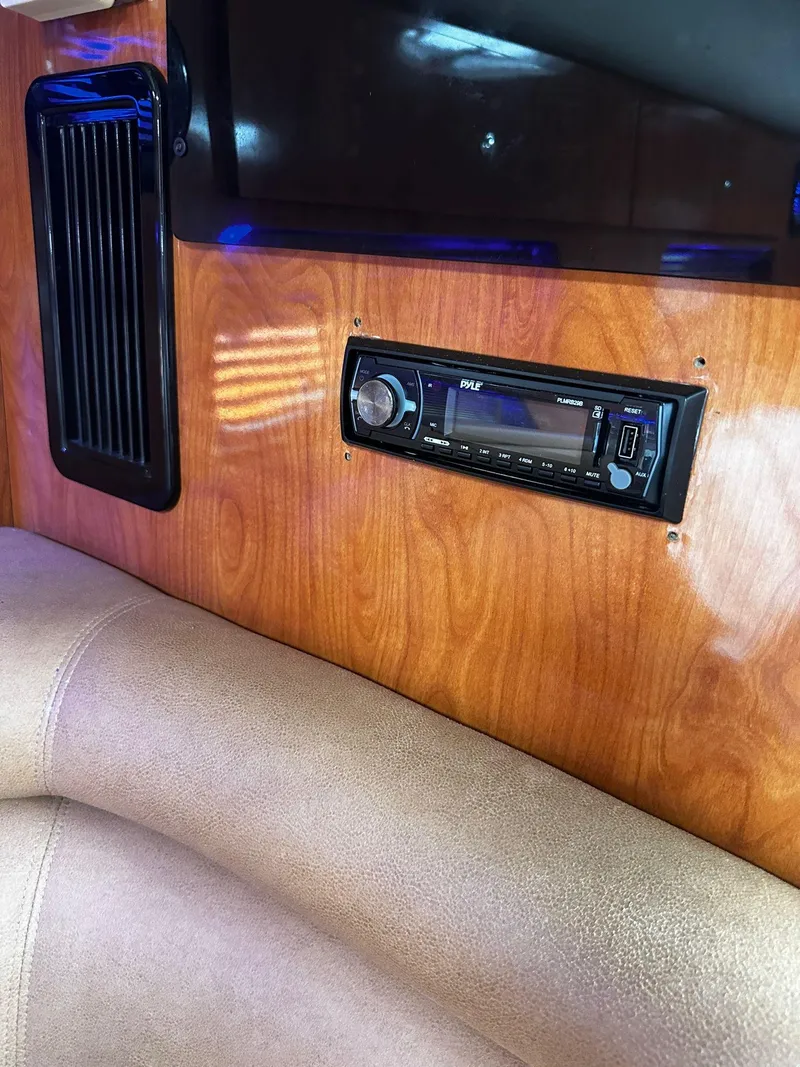 Slide: The Image of Interior of 2006 Four Winns 328 Vista with stereo system and wood paneling. - 30