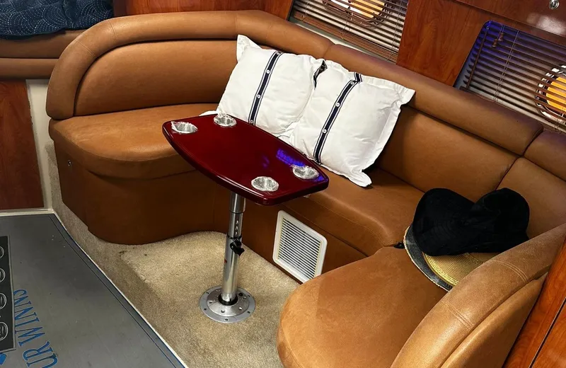 Slide: The Image of Luxurious interior seating area of a 2006 Four Winns 328 Vista boat with a small table. - 34