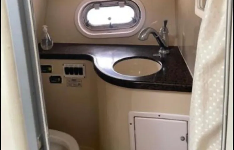 Slide: The Image of 2006 Four Winns 328 Vista boat bathroom with sink, toilet, and porthole window. - 36