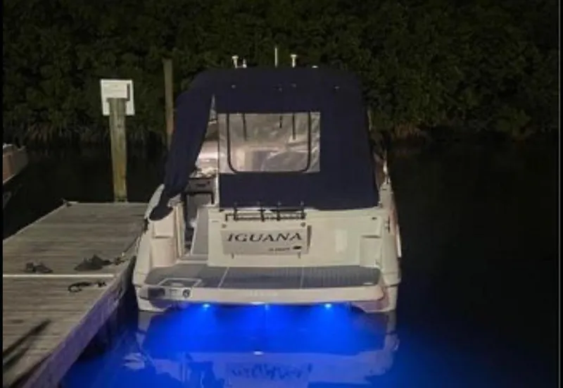 Slide: The Image of 2006 Four Winns 328 Vista boat docked at night with blue underwater lights. - 37