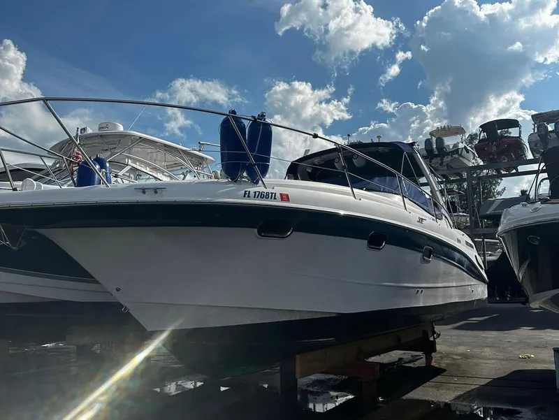 Slide: The Image of 2006 Four Winns 328 Vista boat docked under a partly cloudy sky. - 4